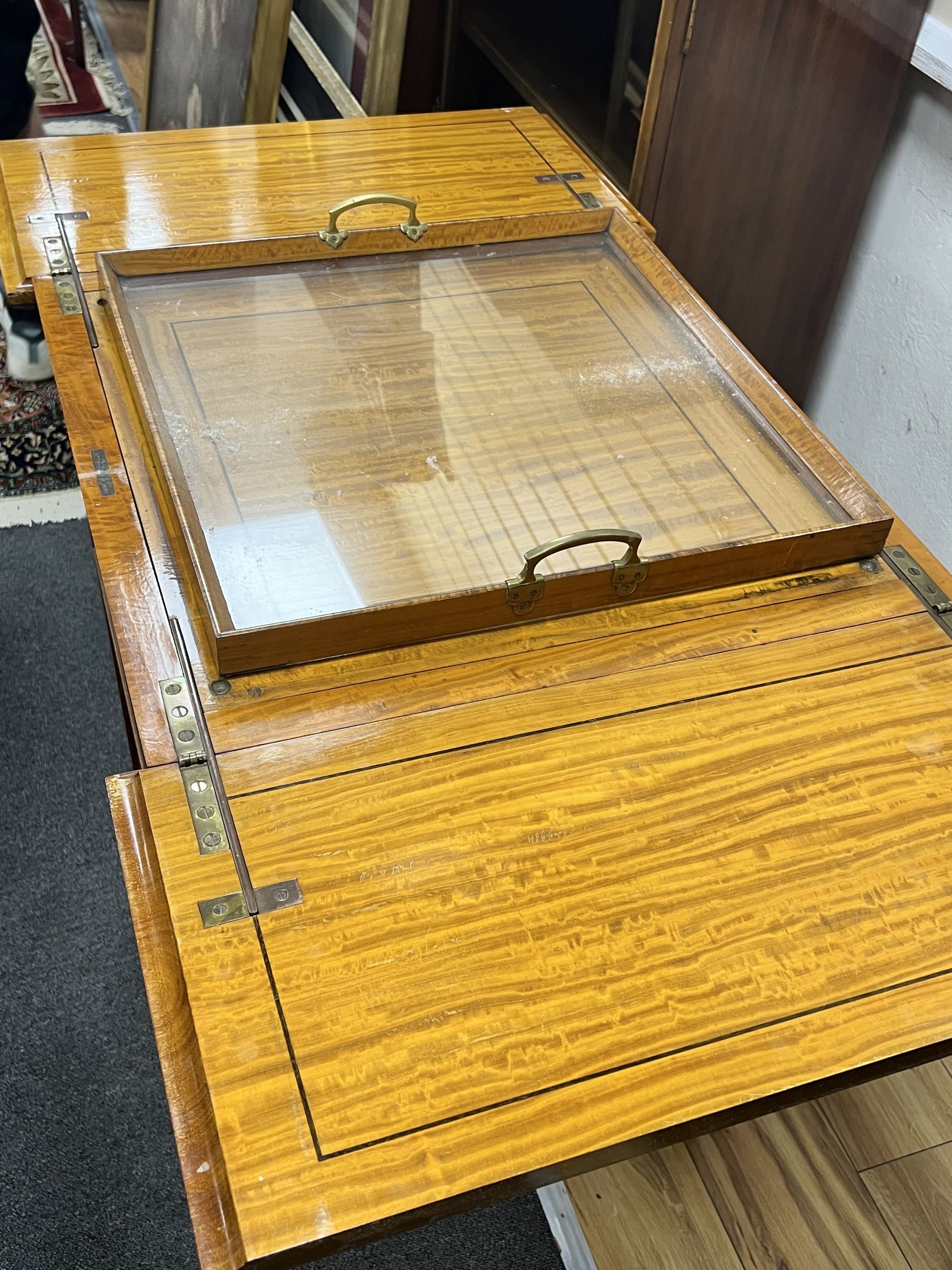 An Edwardian banded satinwood mahogany surprise drinks cabinet by Maple & Co, banded in kingwood and inlaid with husk festoons, divided opening top with rising interior, circa 1900., width 56cm depth 59cm height 78cm